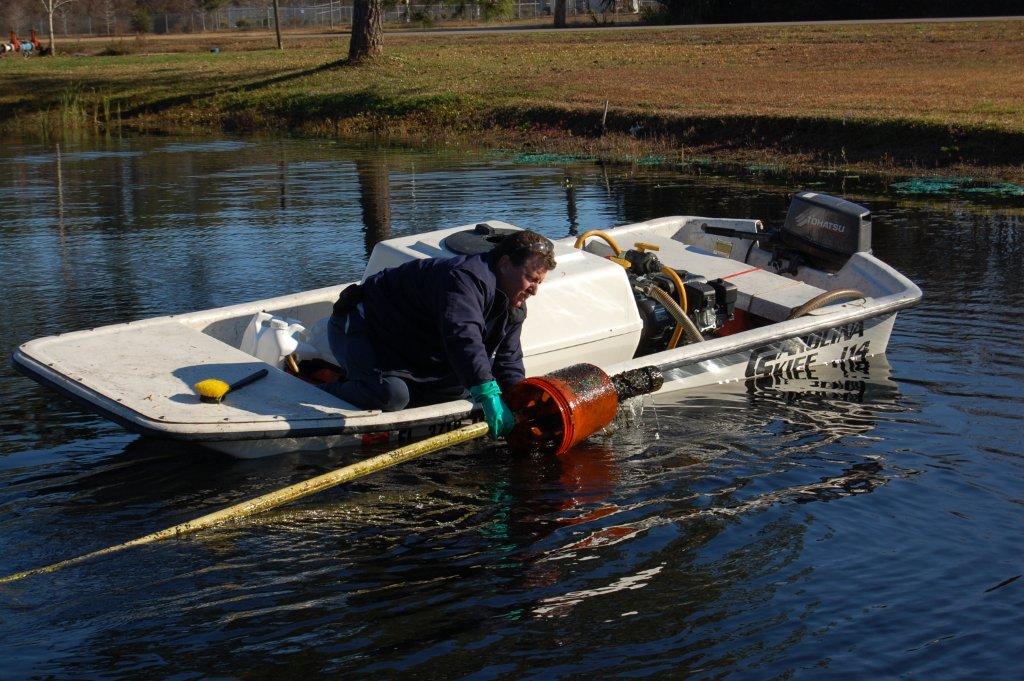 Lake Doctors Technicial Performing Maintenance over a boat