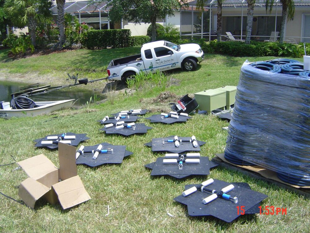 Fountain aeration equipment laid out by the side of a lake.