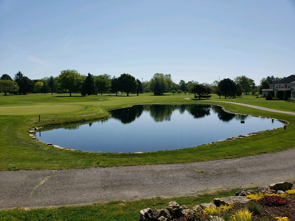A clean, scenic lake on a golf course.